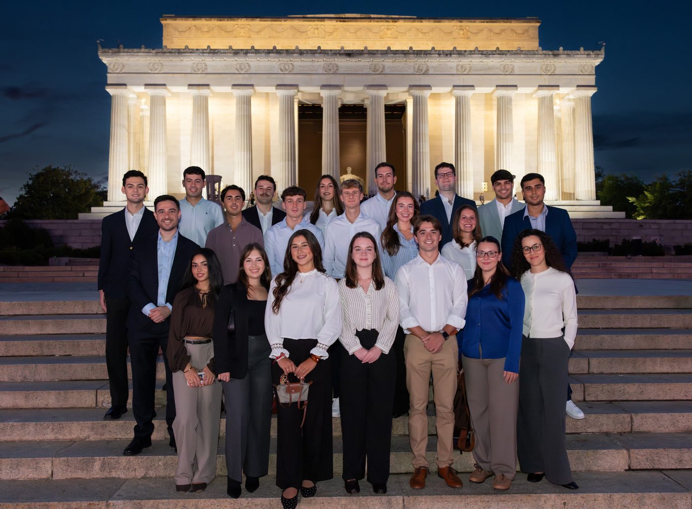 The Fall 2026 scholars on the steps of the Lincoln Memorial at night
